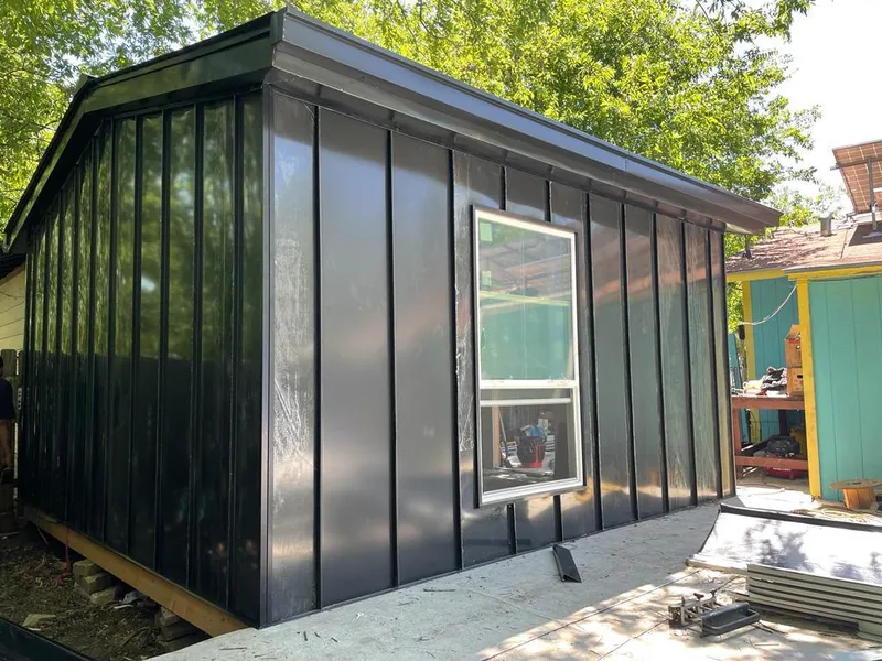 Black standing seam metal wall panels for Roof Inspection in Chackbay